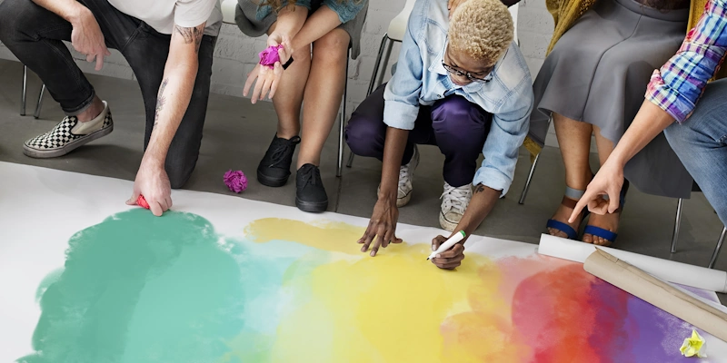 Team members around a vibrant sheet of paper, brainstorming branding concepts for a practice website.