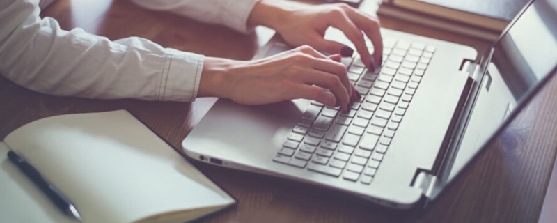 A person working on blogging ideas on a laptop