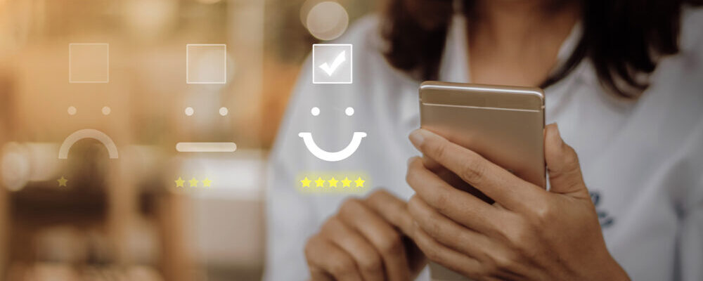 Woman using smartphone for Medical Online Reviews with feedback icons overlayed: sad, neutral, and happy faces with stars.