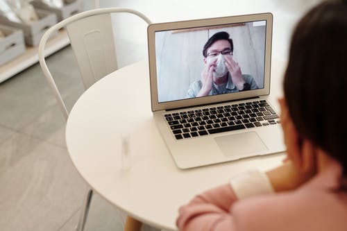 Person video calling on a laptop for podiatry advertising