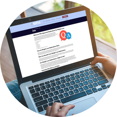 A person typing on a laptop displaying cardiology ‎website design with FAQs.